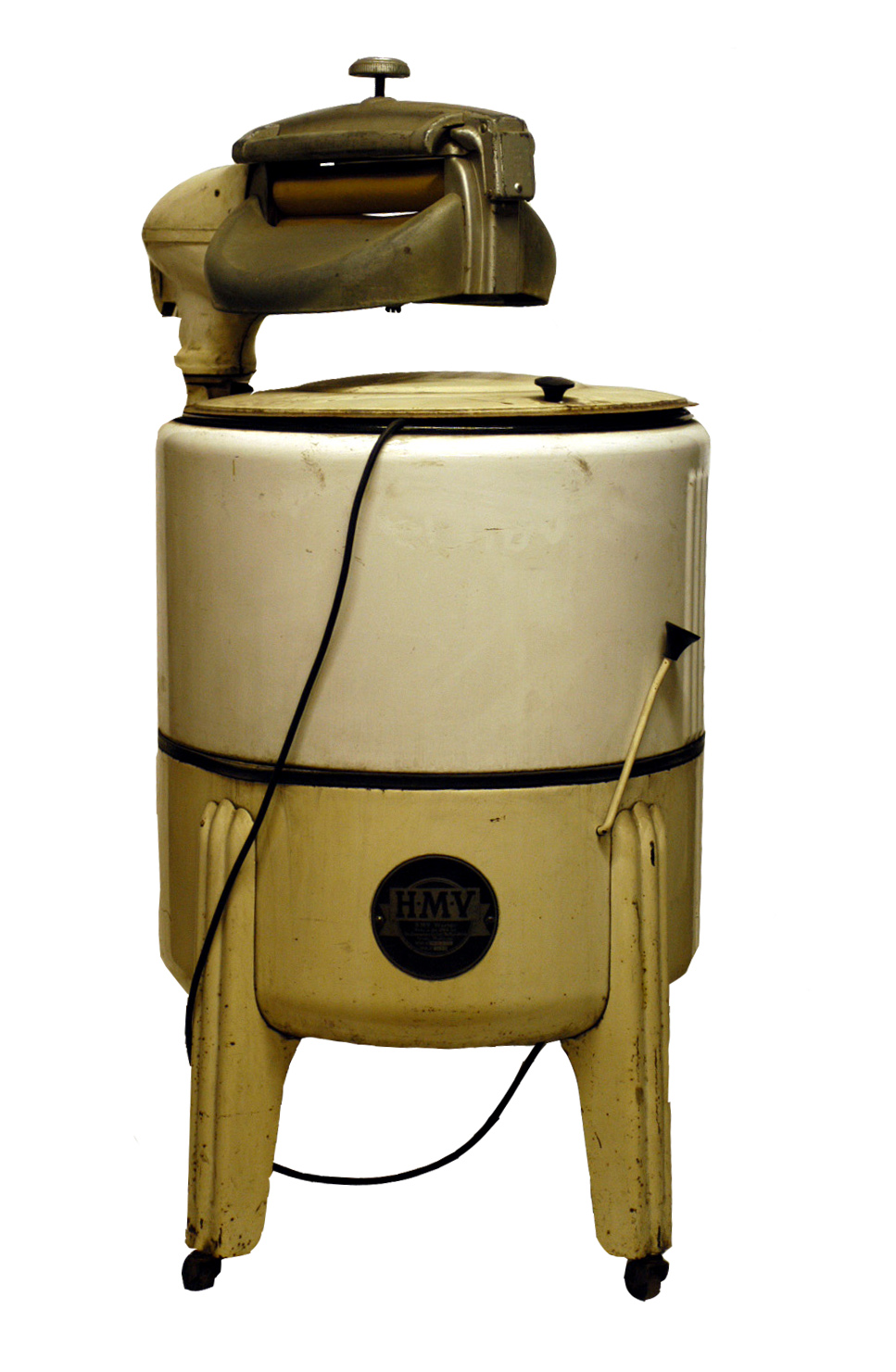 Colour photograph showing a washing machine. There is a large drum section on the bottom and it is top loaded. Over the lid is a small mangle.