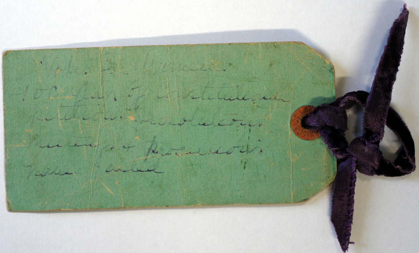 The label Leonora tied around the iron bar she used to smash the Tower of London display case.