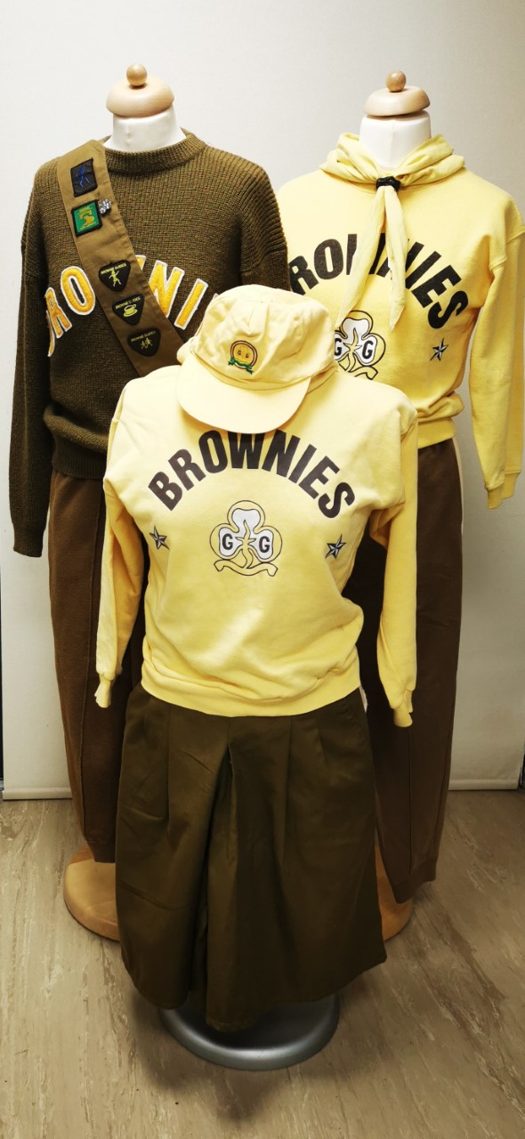 Colour photograph showing a variety of different Brownie uniforms