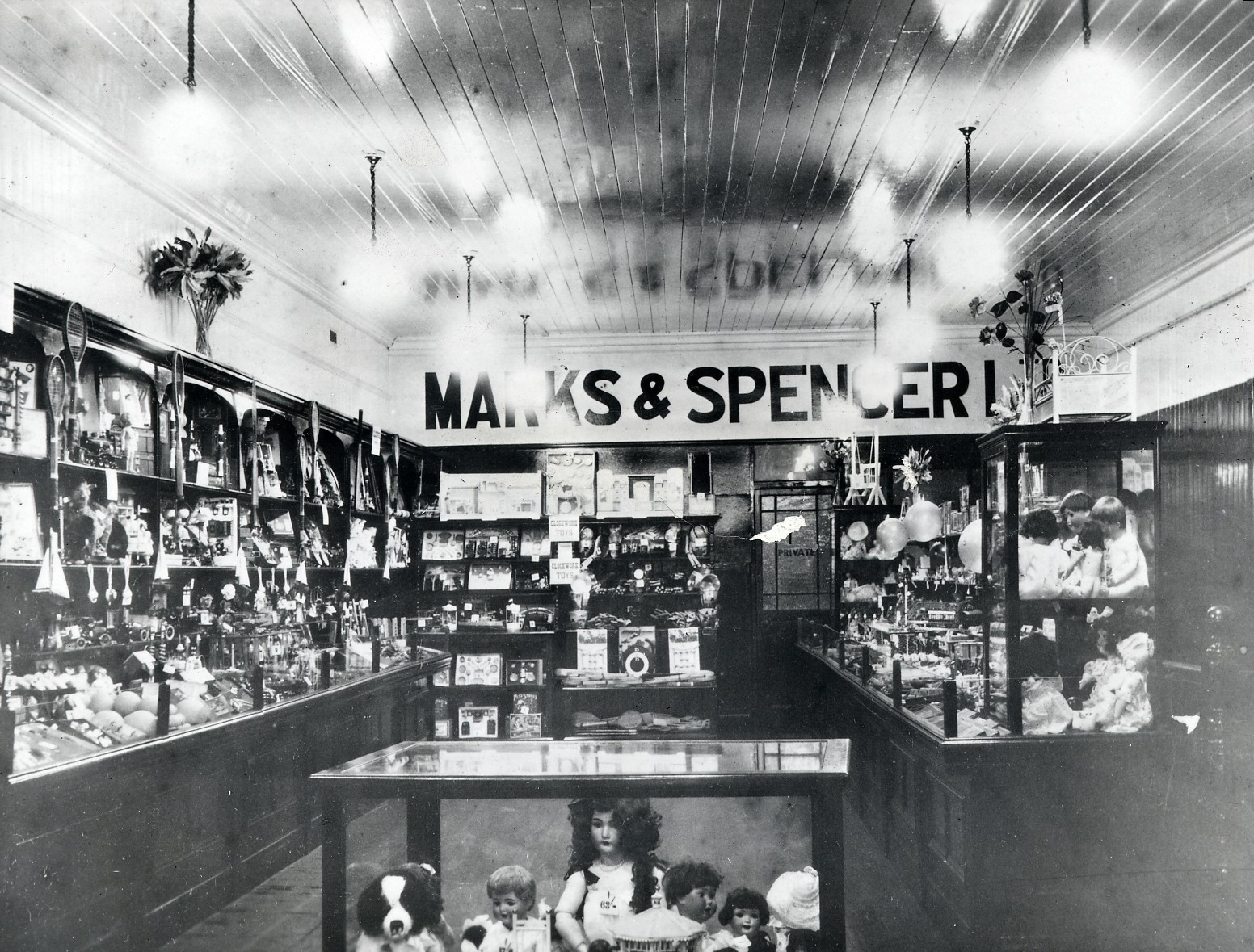 Black and white photograph showing an M&S storefront