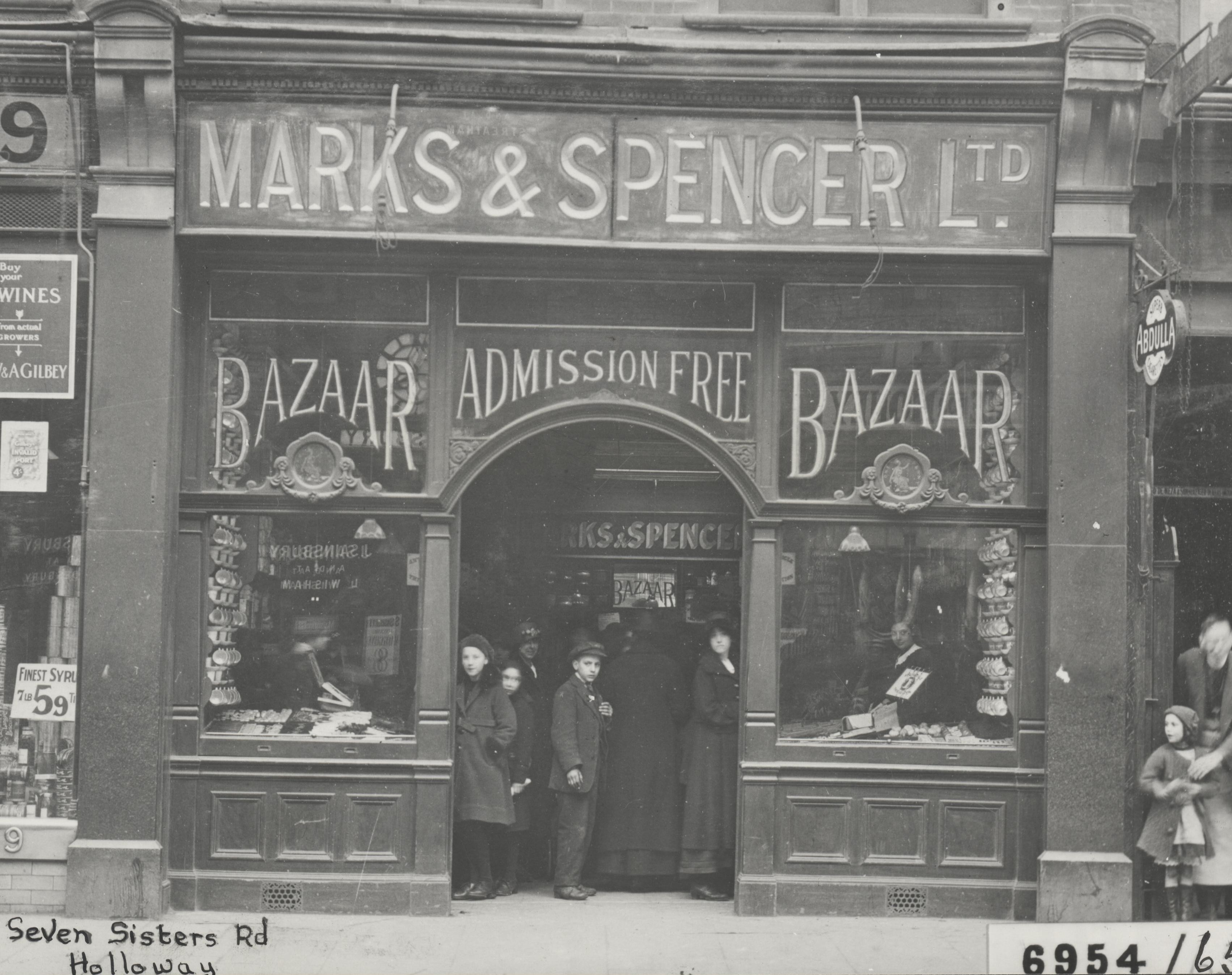 Black and white photograph showing the front of an M&S shop