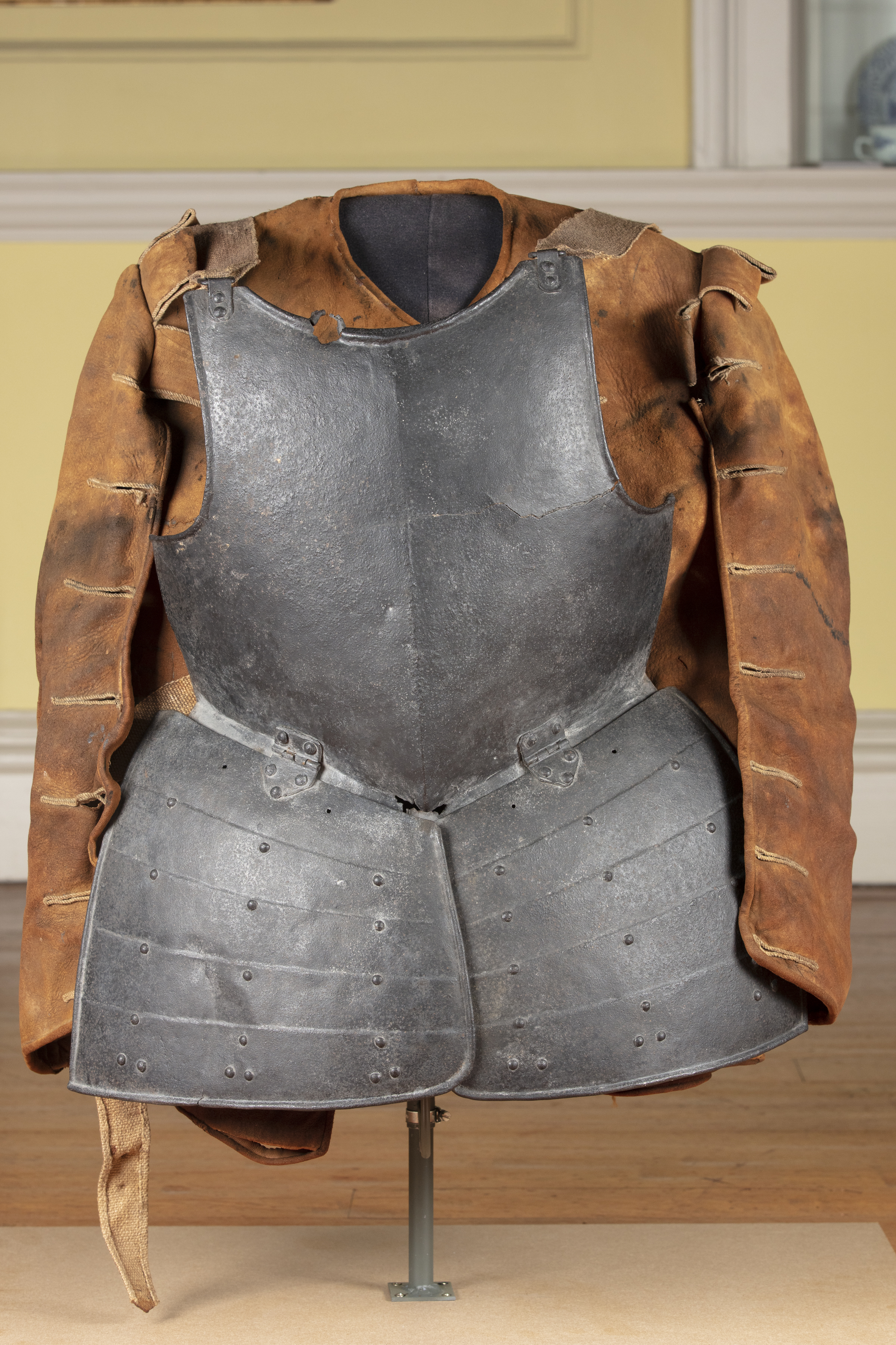 Civil War armour, breastplate and jacket hanging on a display stand