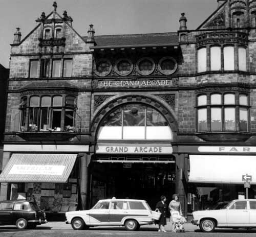 Black and white photograph of the outside of the Grand. The building has bay windows and lots of decoration.