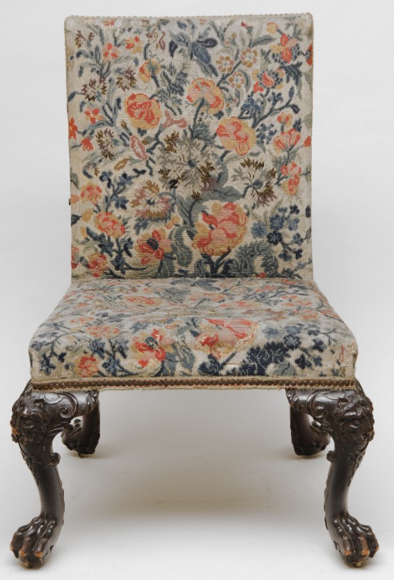 Straight backed chair with no sides. Padded seat and back, completely covered in embroidery with a design of flowers