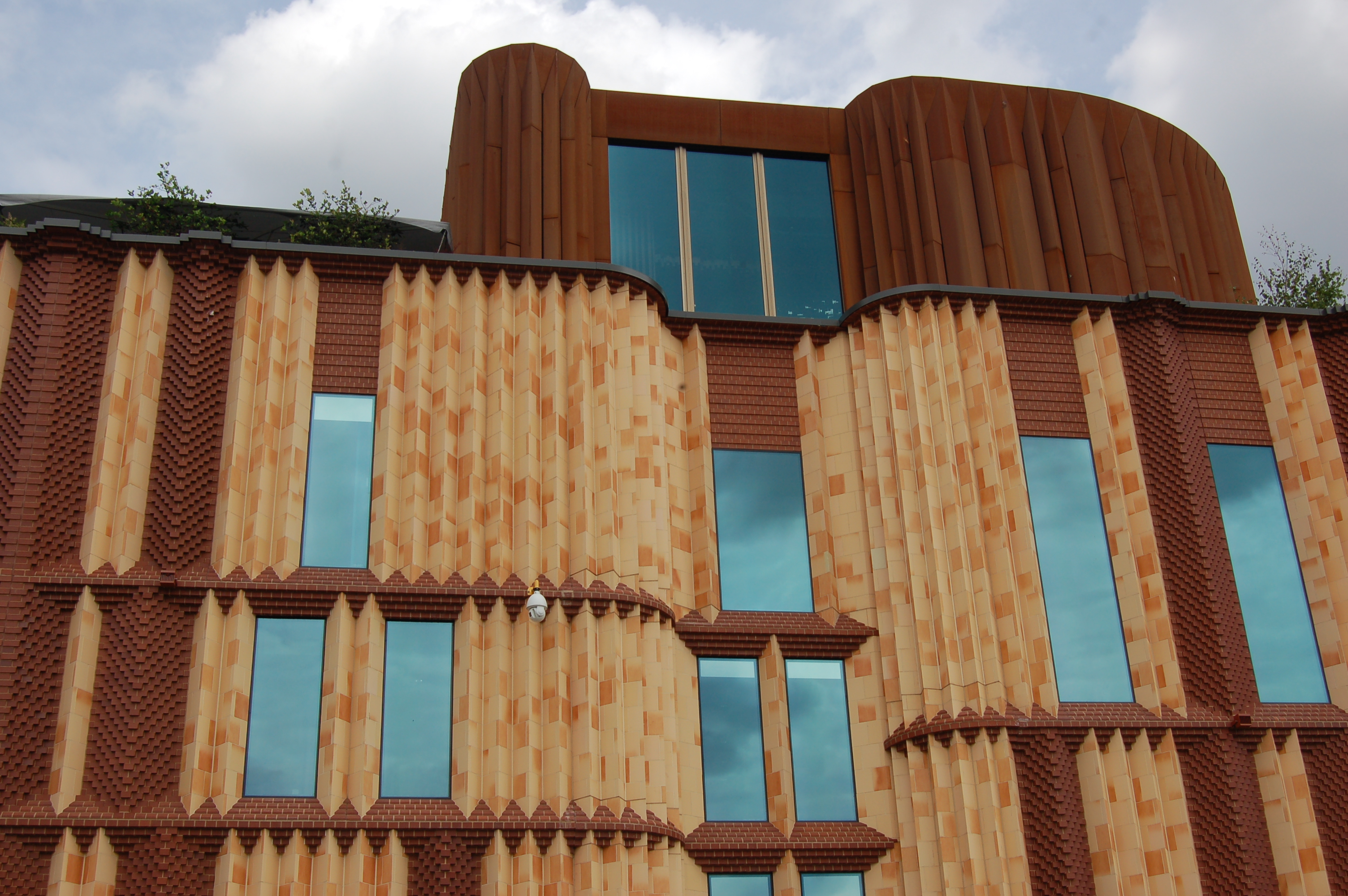 Contemporary photograph showing part of the Victora Gate complex, with red brick and tall, narrow windows.