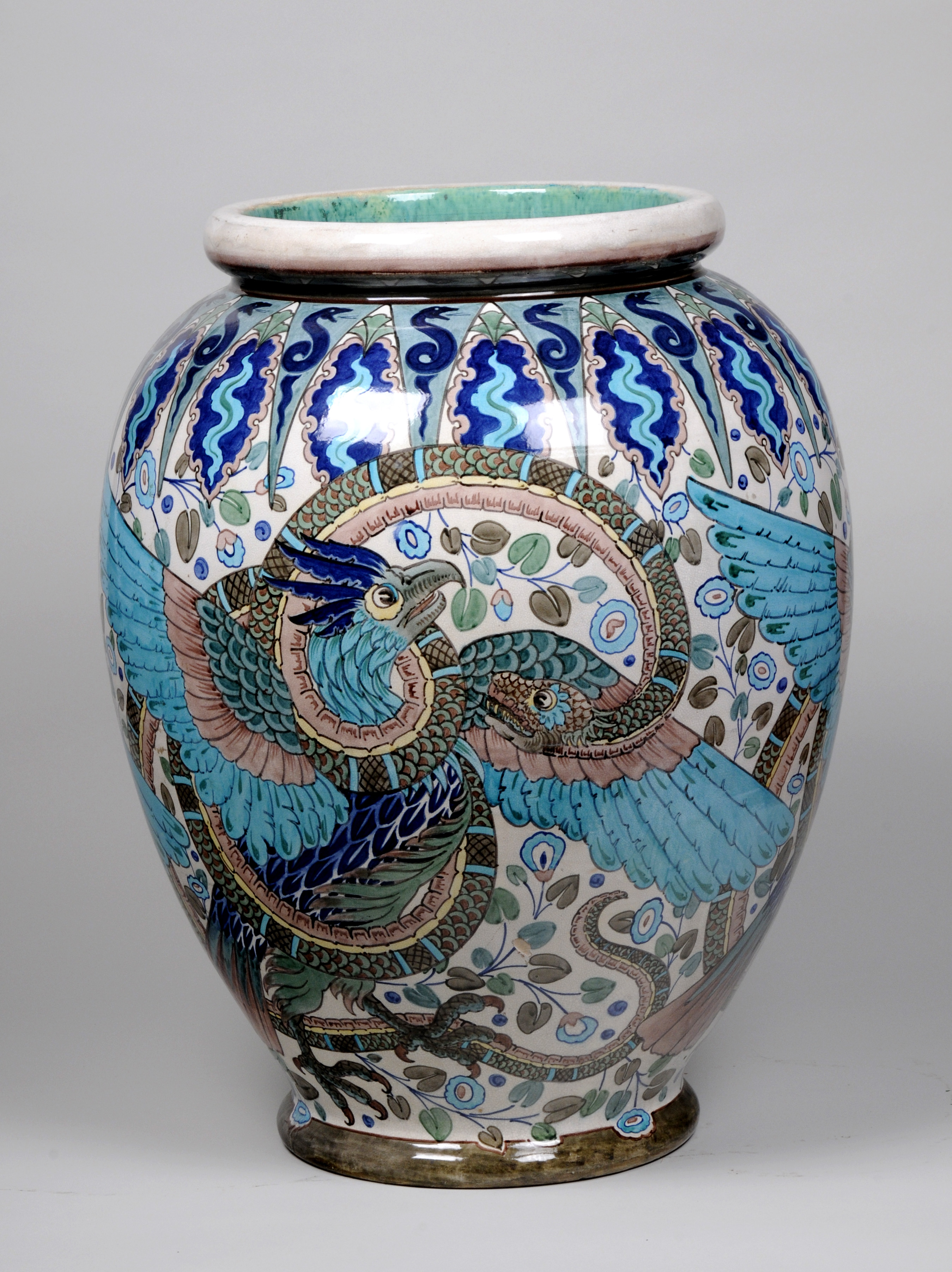 Ceramic vase in shades of blue glaze, with a phoenix and snake design.