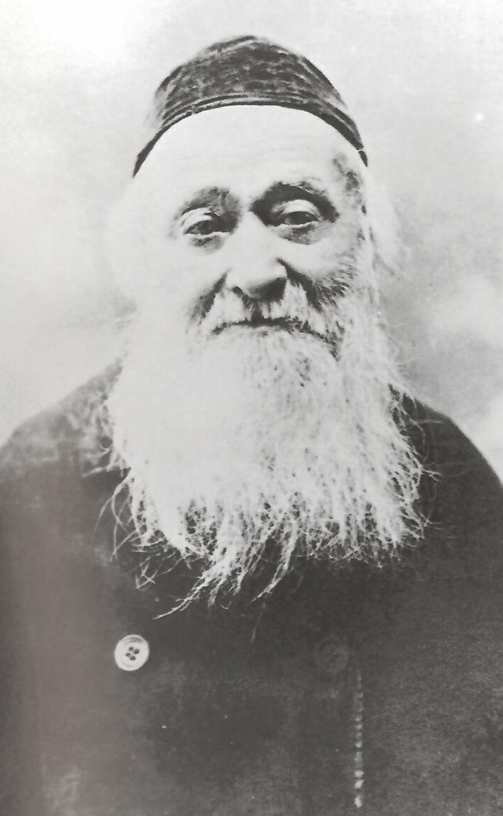 Black and white portrait photograph of an elderly man  with long white beard wearing Jewish skull cap