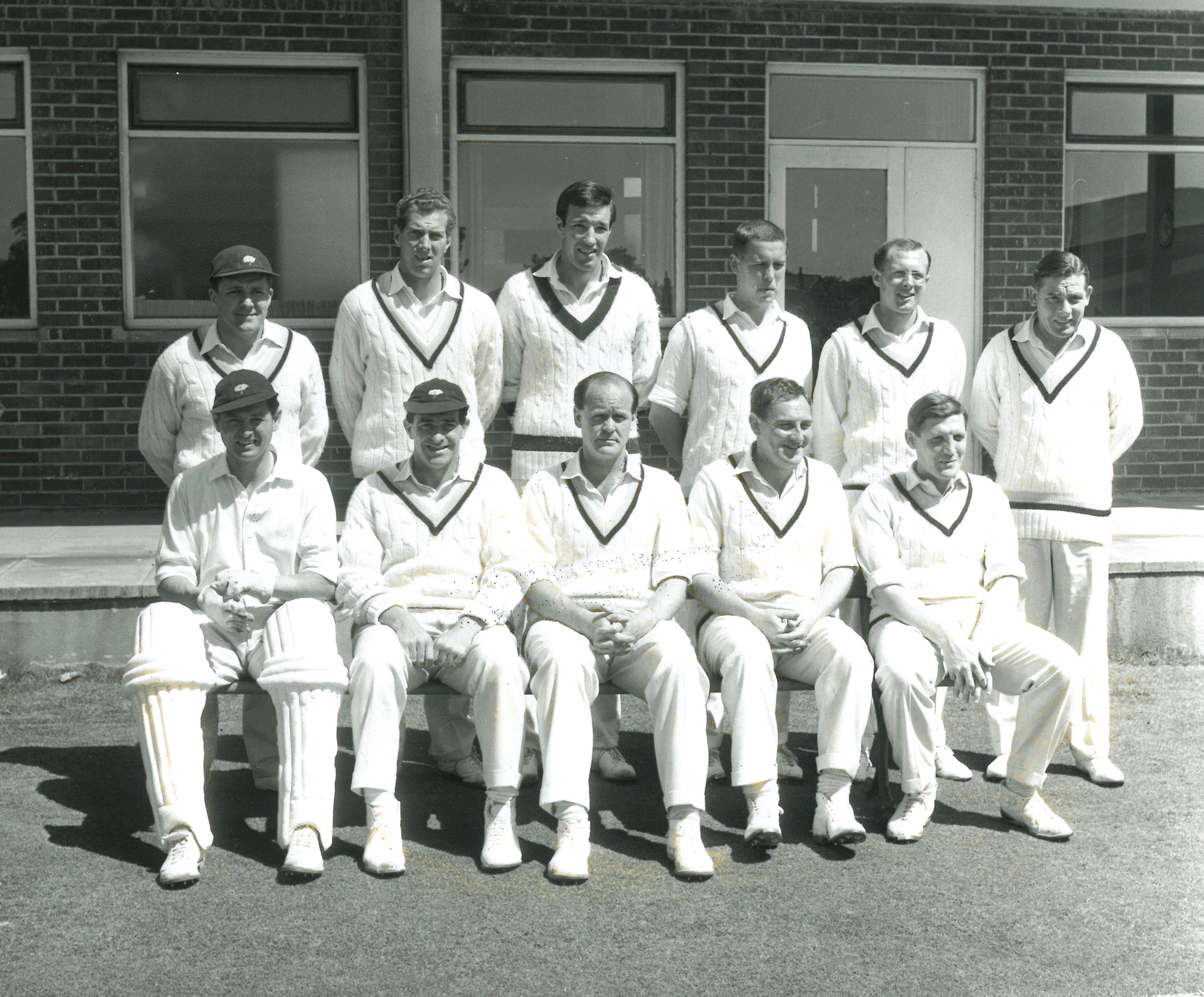Black and white image of a mens cricket team in uniform