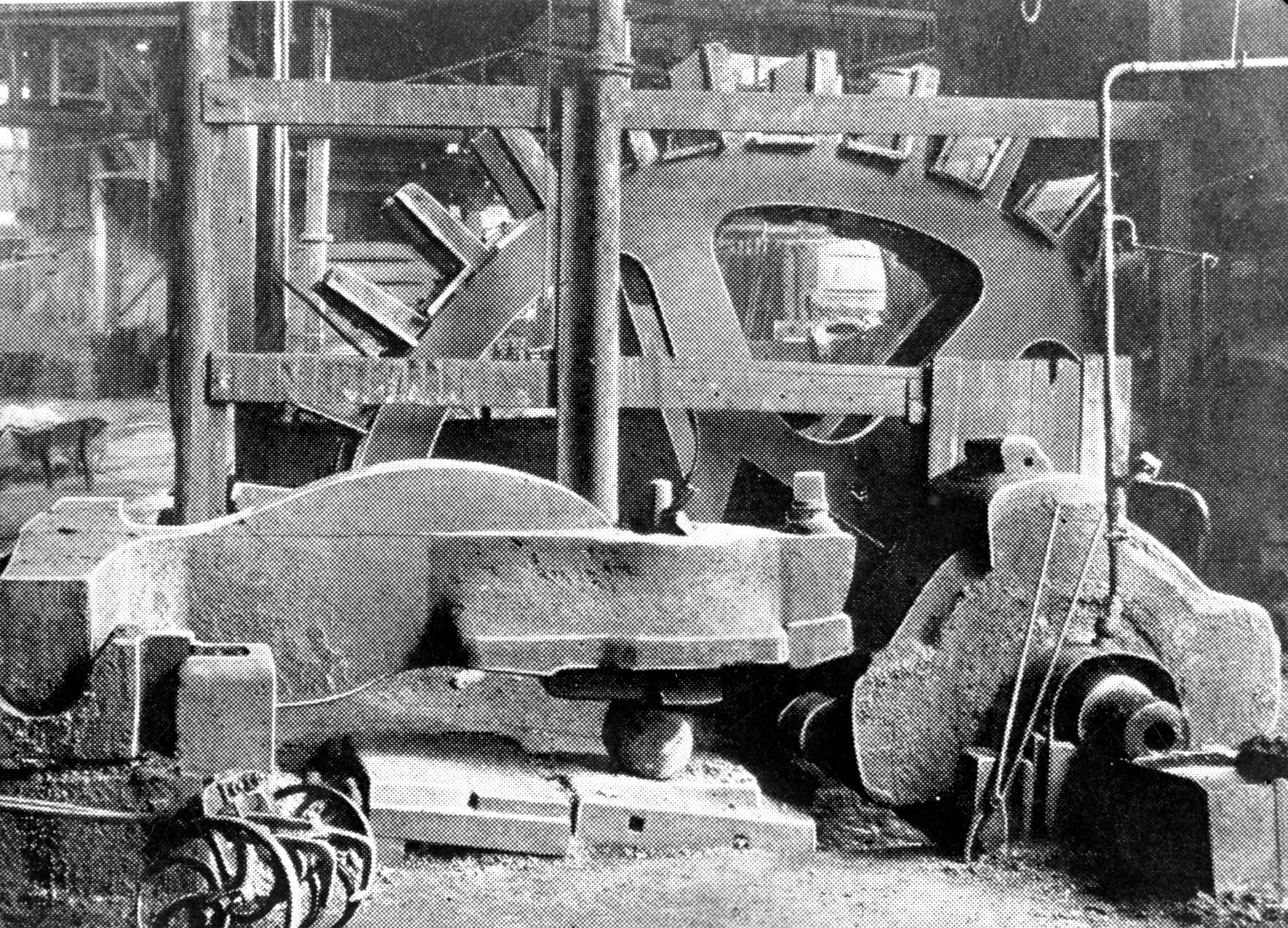 Black and white photograph of a large metal water wheel