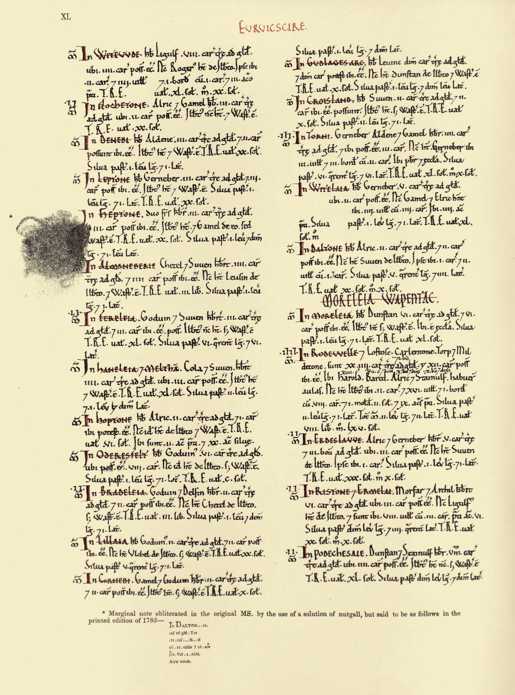 A yellowed page from a manuscript with two columns of dense, handwritten text in dark ink. A large ink smudge appears on the left side.