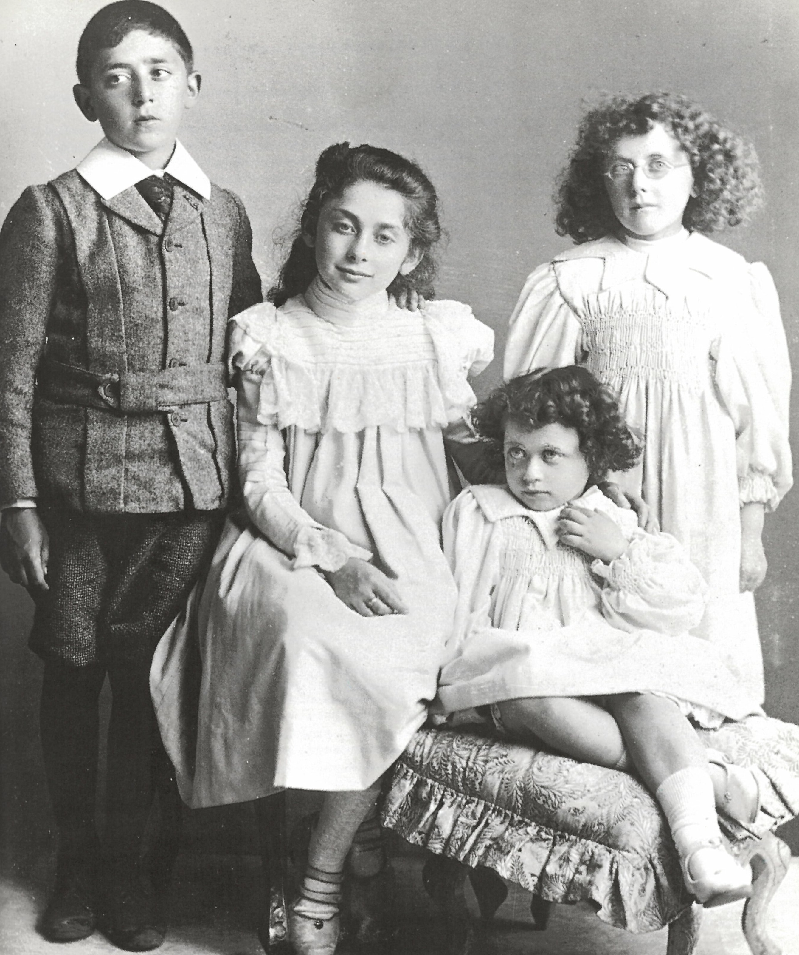 Black and white family portrait photo of 3 young girls and a young boy