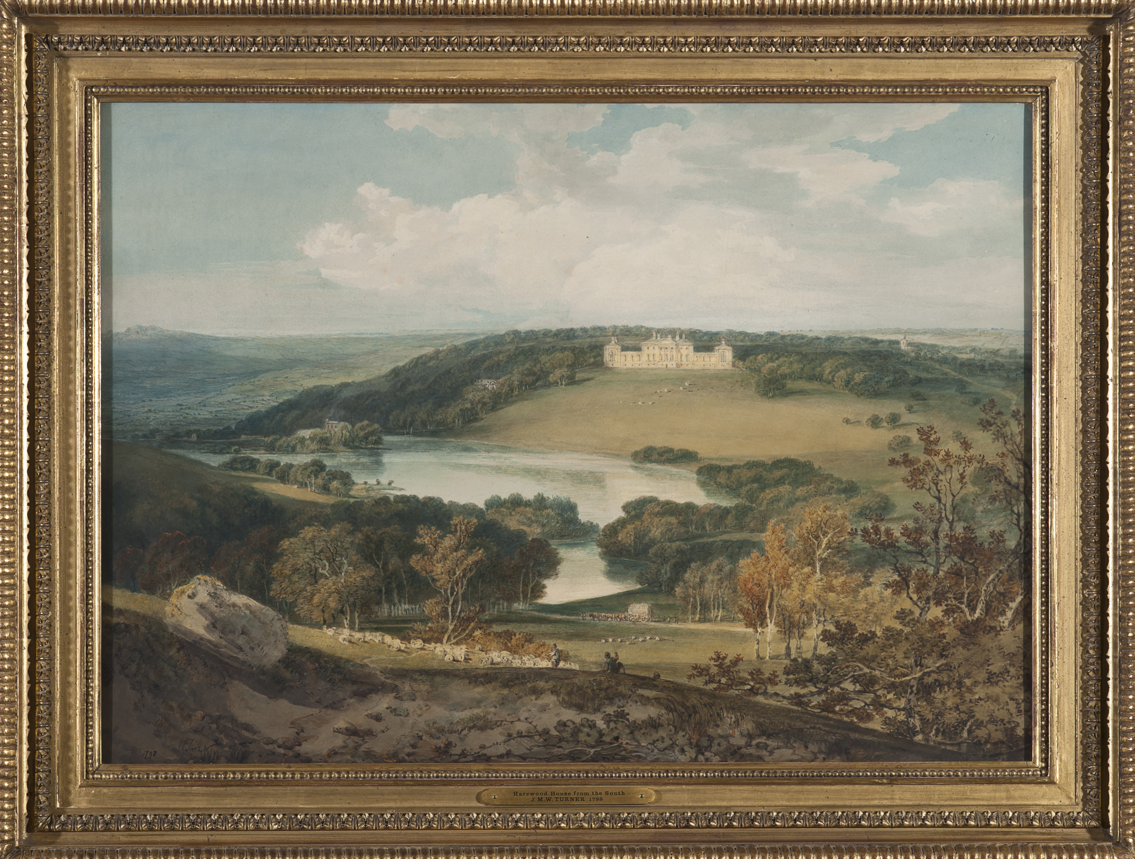 Landscape painting showing Harewood House set in grounds landscaped by Capability Brown.  The foreground shows a 'wild' looking landscape of rocks, grassland and trees, with a lake in the midground and the house sitting on top of a hill in the background.