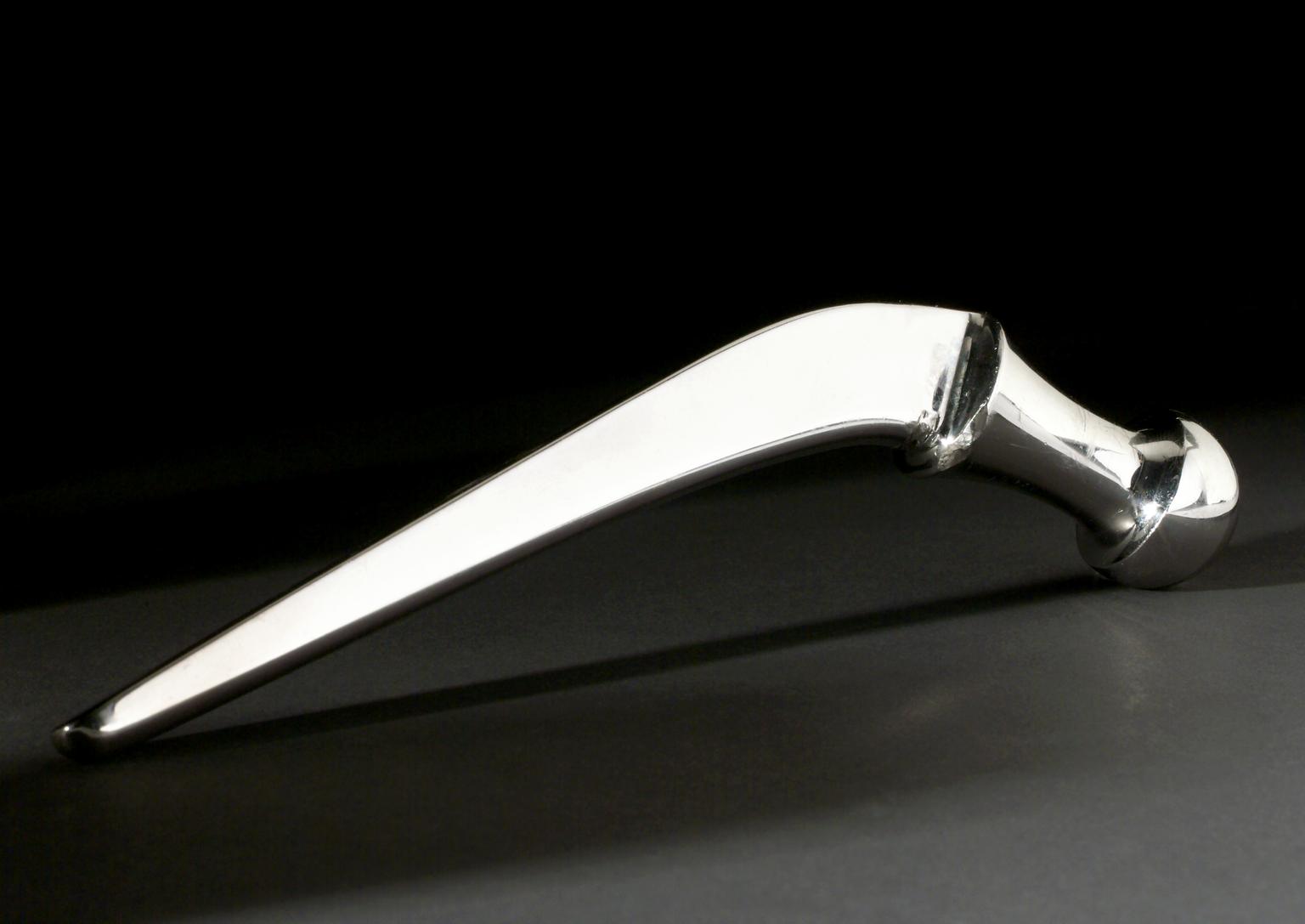 Metal prosthetic hip joint with a ball shape at one end