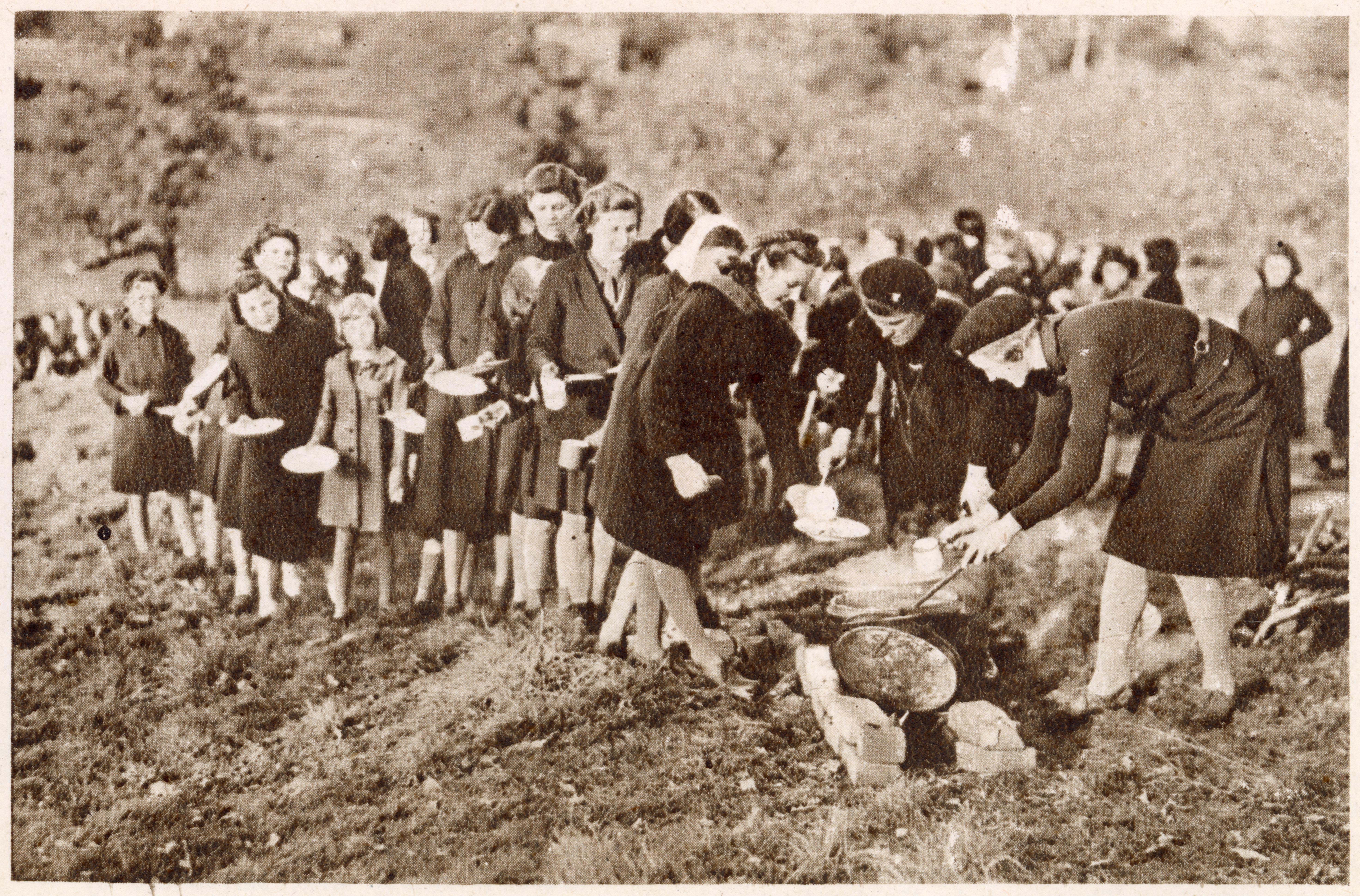 Girls queuing up for food provided by Girl Guides on Guide International Service training.