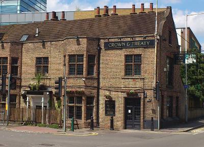 Colour photo brick built country pub exterior with 'Crown and Treaty' sign