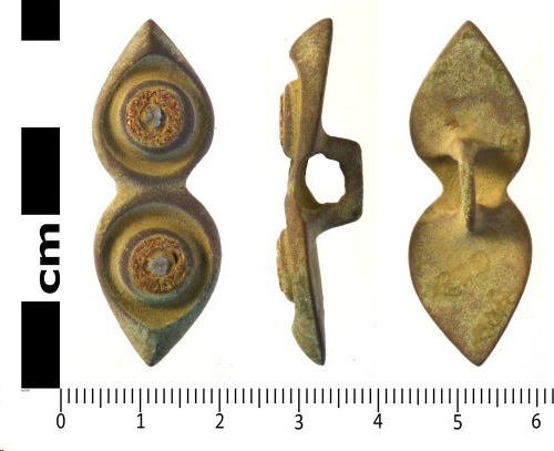 Colour photograph showing three views of the object - front , side a back. It is the shape of two teardrops stuck together with the points facing away from each other.