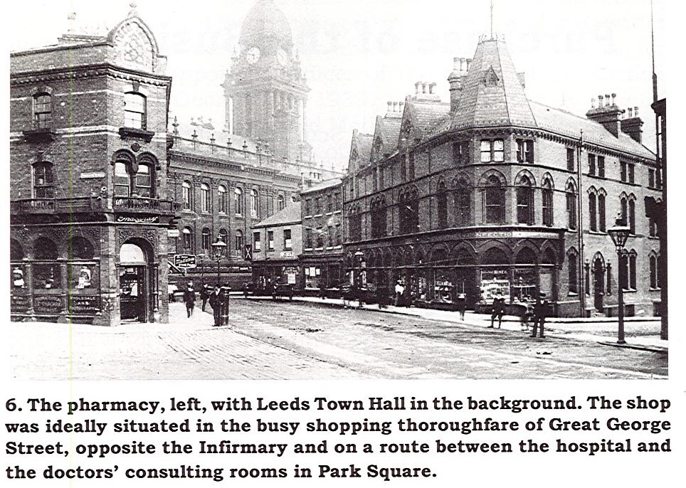 Black and white photo showing the exterior of Thackray's pharmacy with Leeds Town Hall in the background.