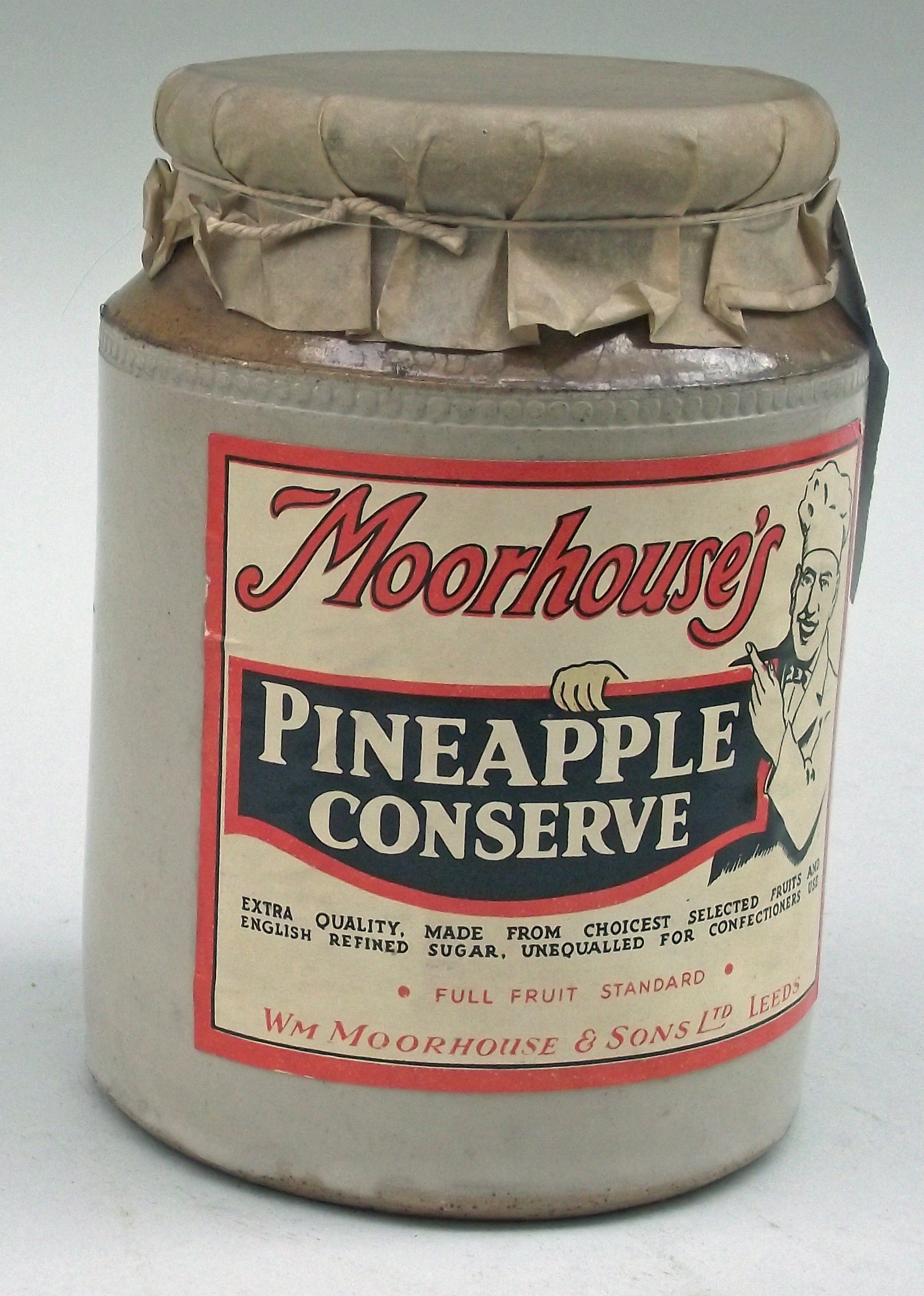 Colour photograph of a ceramic jar with a label with Pineapple Conserve on it