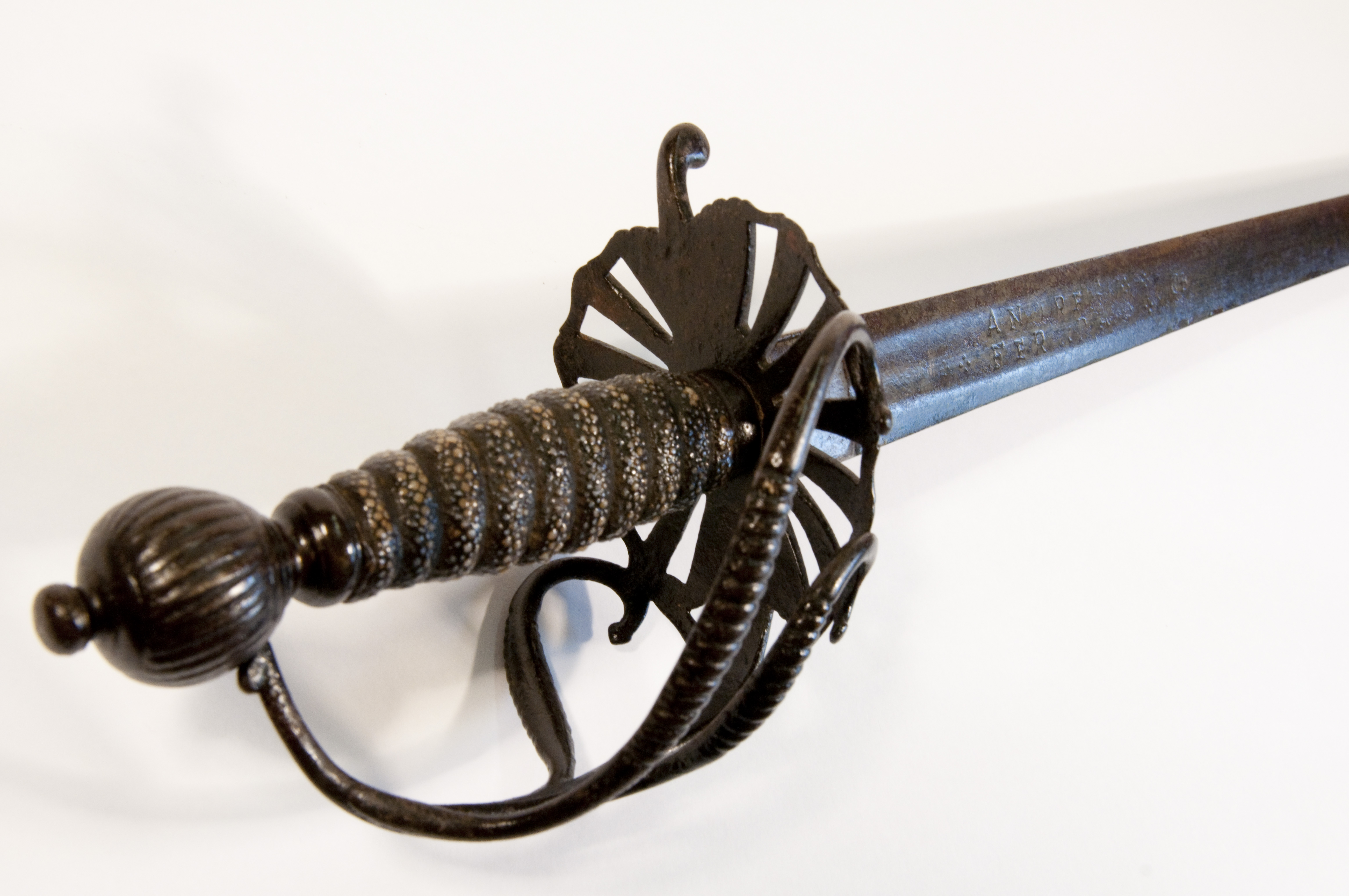Photo of a dark coloured metal Civil War Ferrara sword handle