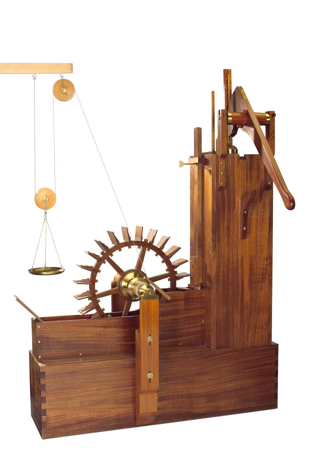 A wooden waterwheel model. With levers and pulleys