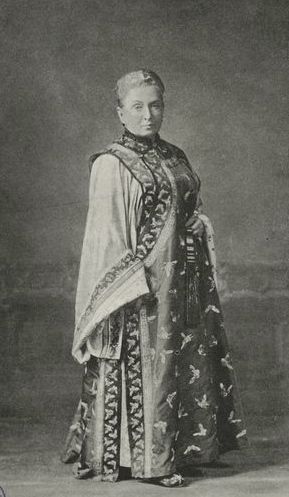 Black and white photograph of Isabella dressed in beautiful dress with a bird print design