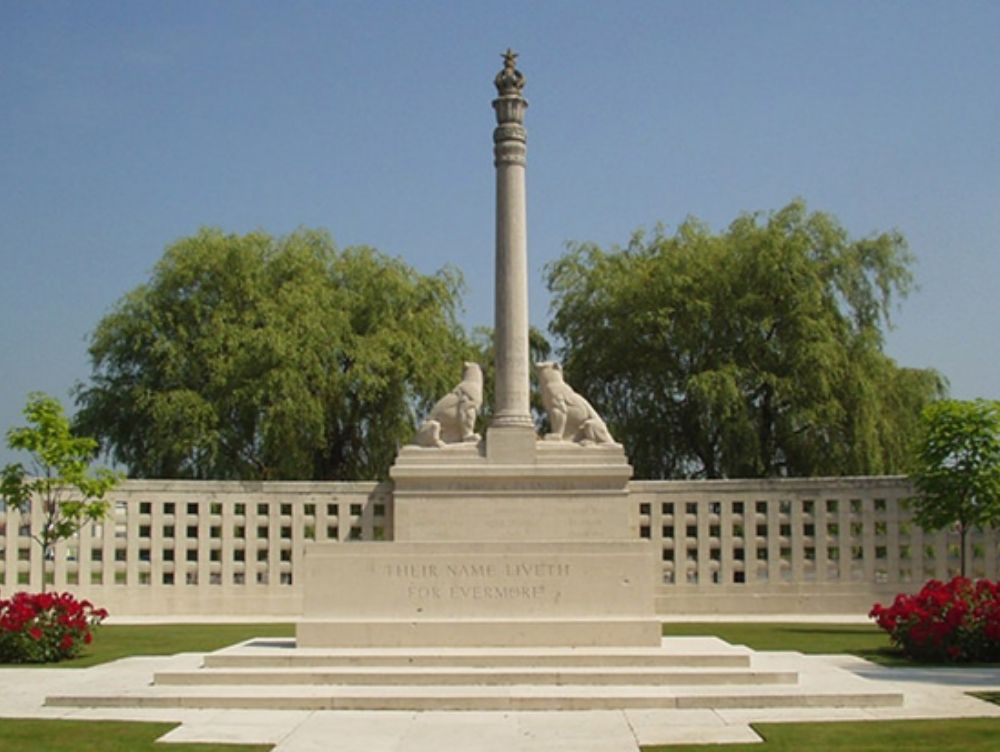 Coloured photograph of a stone built memorial. There is a tall central column and on either side is a cat type animal