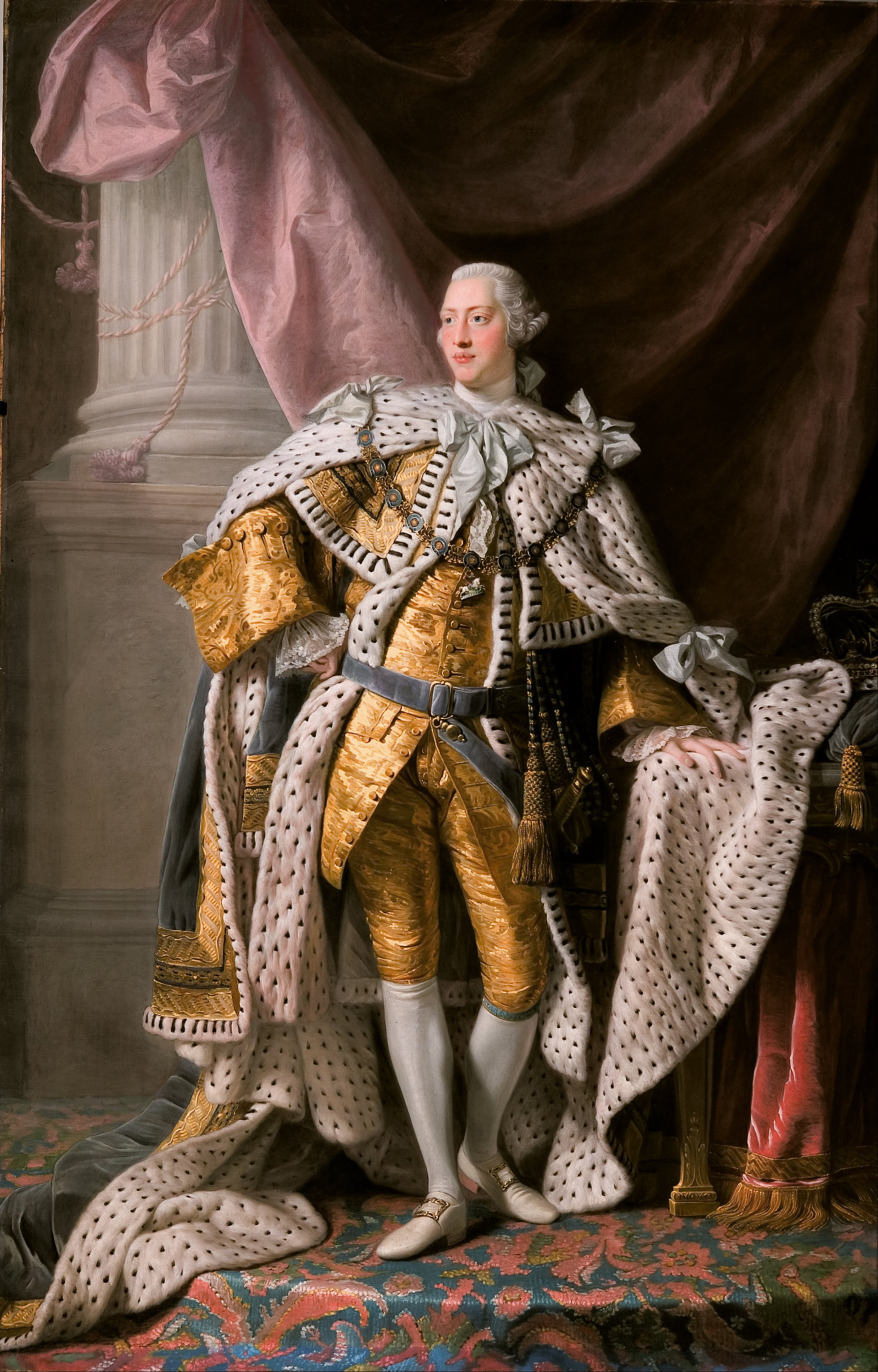 Painting of King George third. In gold and white fur robes resting his left hand on a table. Pillar and background drapes are behind him.