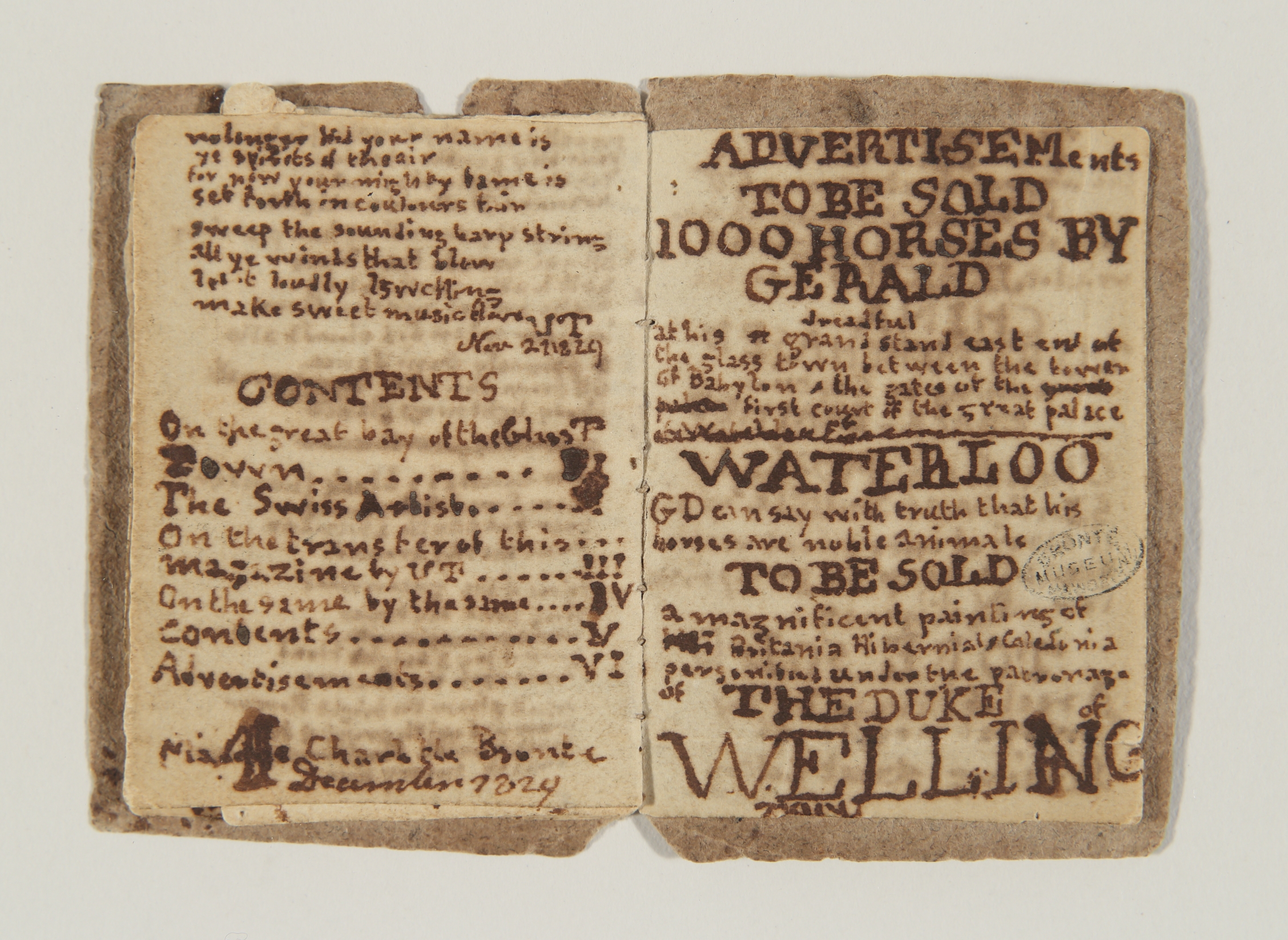 Two pages of small handmade book with handwritten text in brown ink