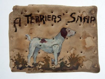WW1 army ration biscuit decorated with a terrier dog and the words 'A Terrier's Snap'