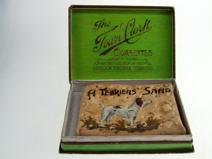 WW1 army ration biscuit decorated with a terrier dog and the words 'A Terrier's Snap' placed in a green box