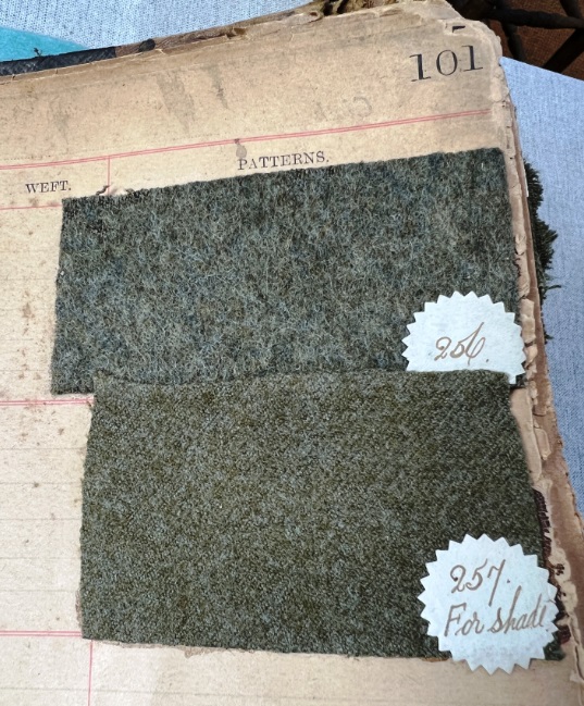 Two swatches of khaki cloth in a guard book