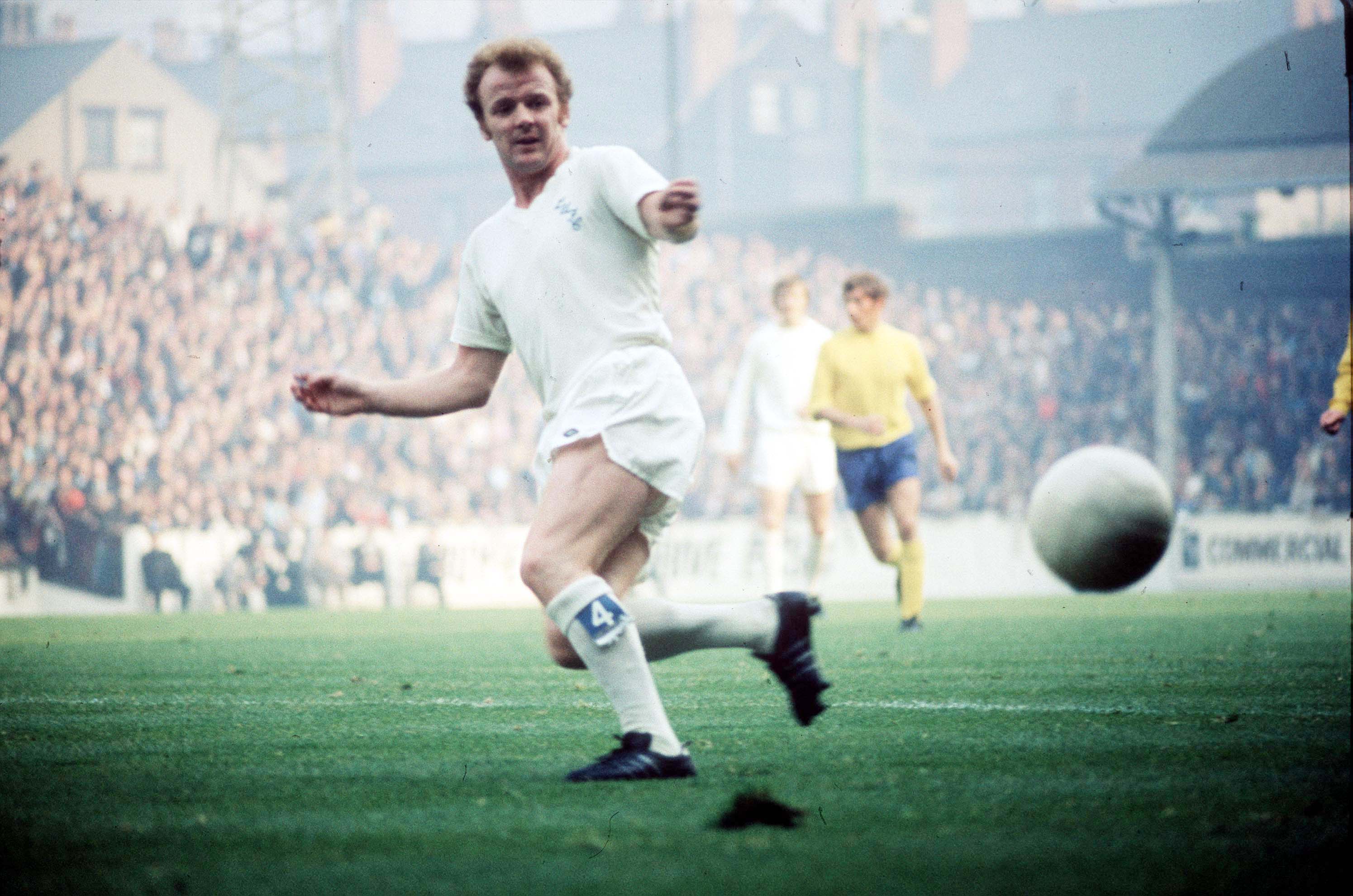 Colour photograph of Billy in all-white kit in the middle of a game