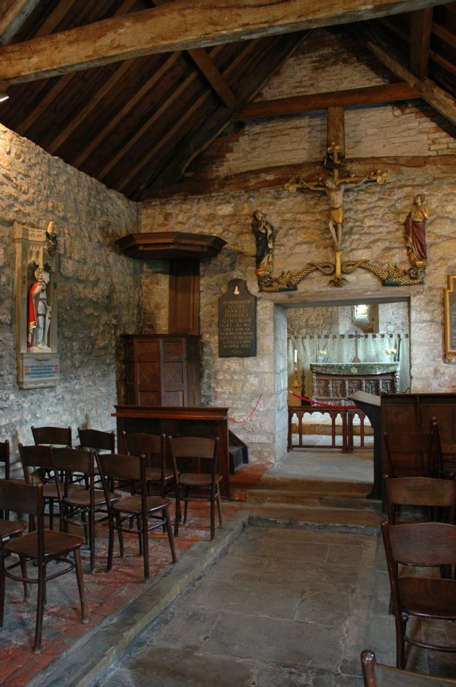 Interior view of a chapel with a carved wooden prayer desk