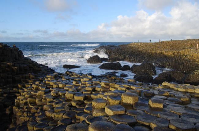 Beach scene with the foreground showing rocks cracked into pentagon shapes