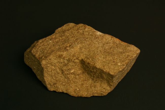 A dark yellow-ish rock with quite a fine texture