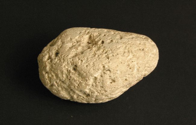 A light coloured stone that is also extremely light in weight.  Surface shows where bubbles of gas have escaped