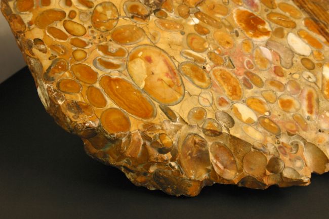 Orange coloured rock made from smaller rocks cemented together.
