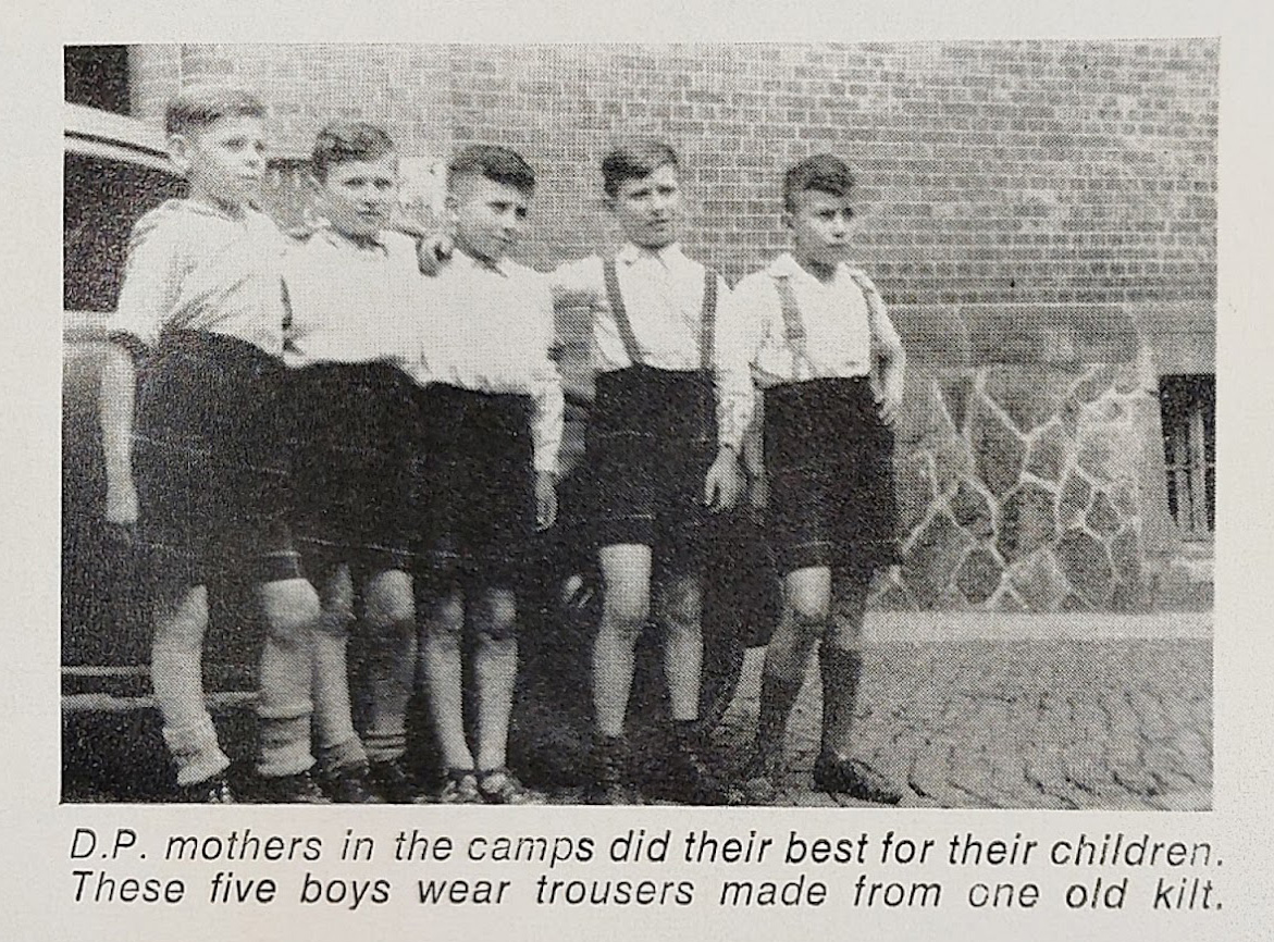 Black and white photo showing five boys wearing tartan shorts