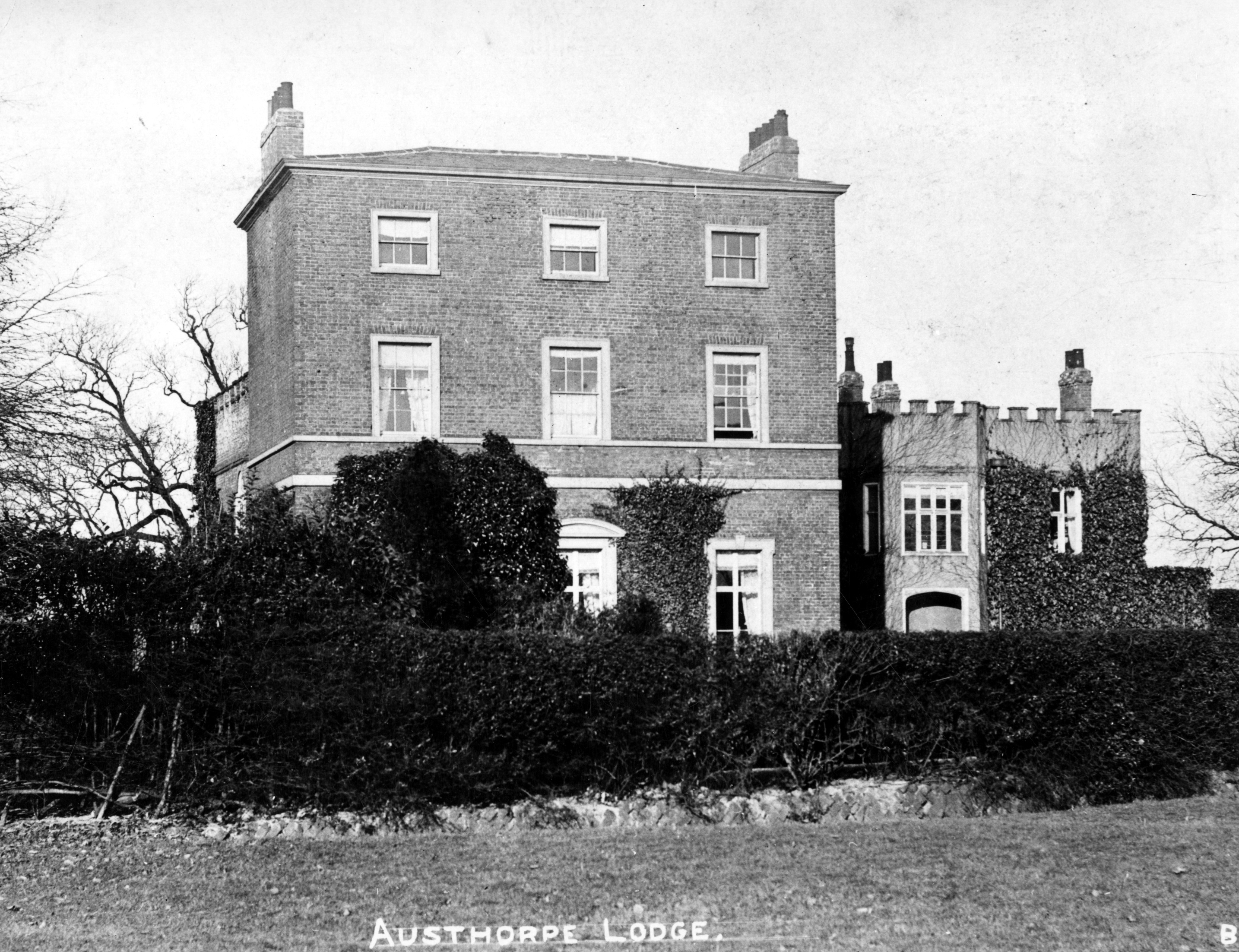 Black and White photograph of a large stone built house.