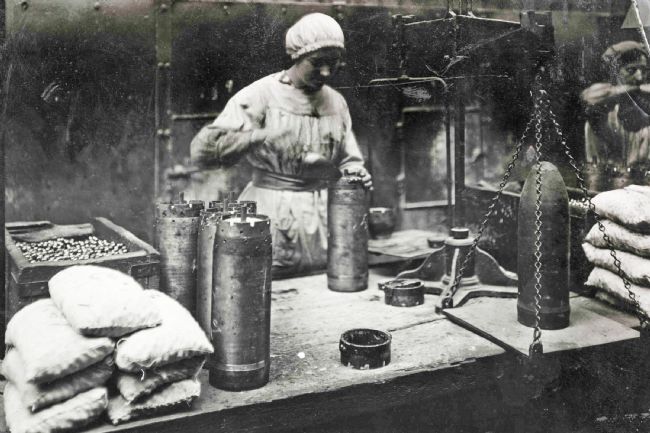 A Preston 'munitionette' filling shells at Dick, Kerr's & Co. munitions works during WW1
