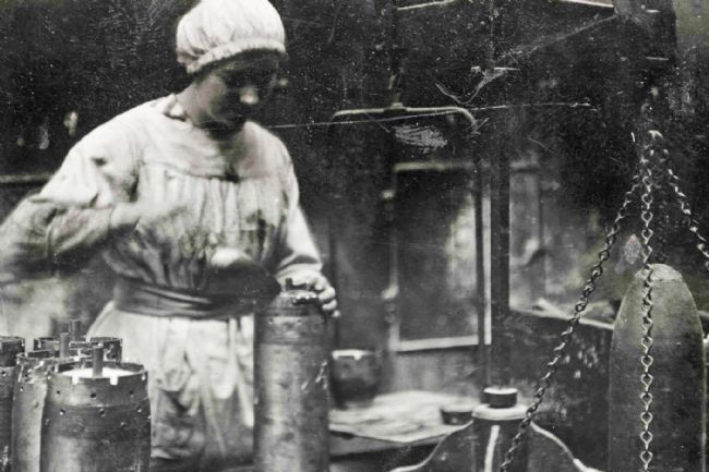 A Preston 'munitionette' filling shells at Dick, Kerr's & Co. munitions works during WW1