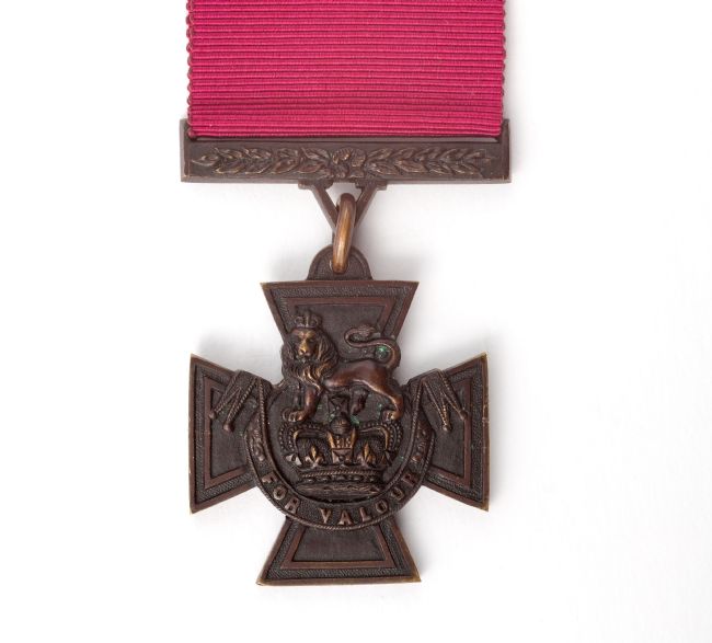 Front of a Victoria Cross medal showing a lion above a crown, with the words 'for valour'