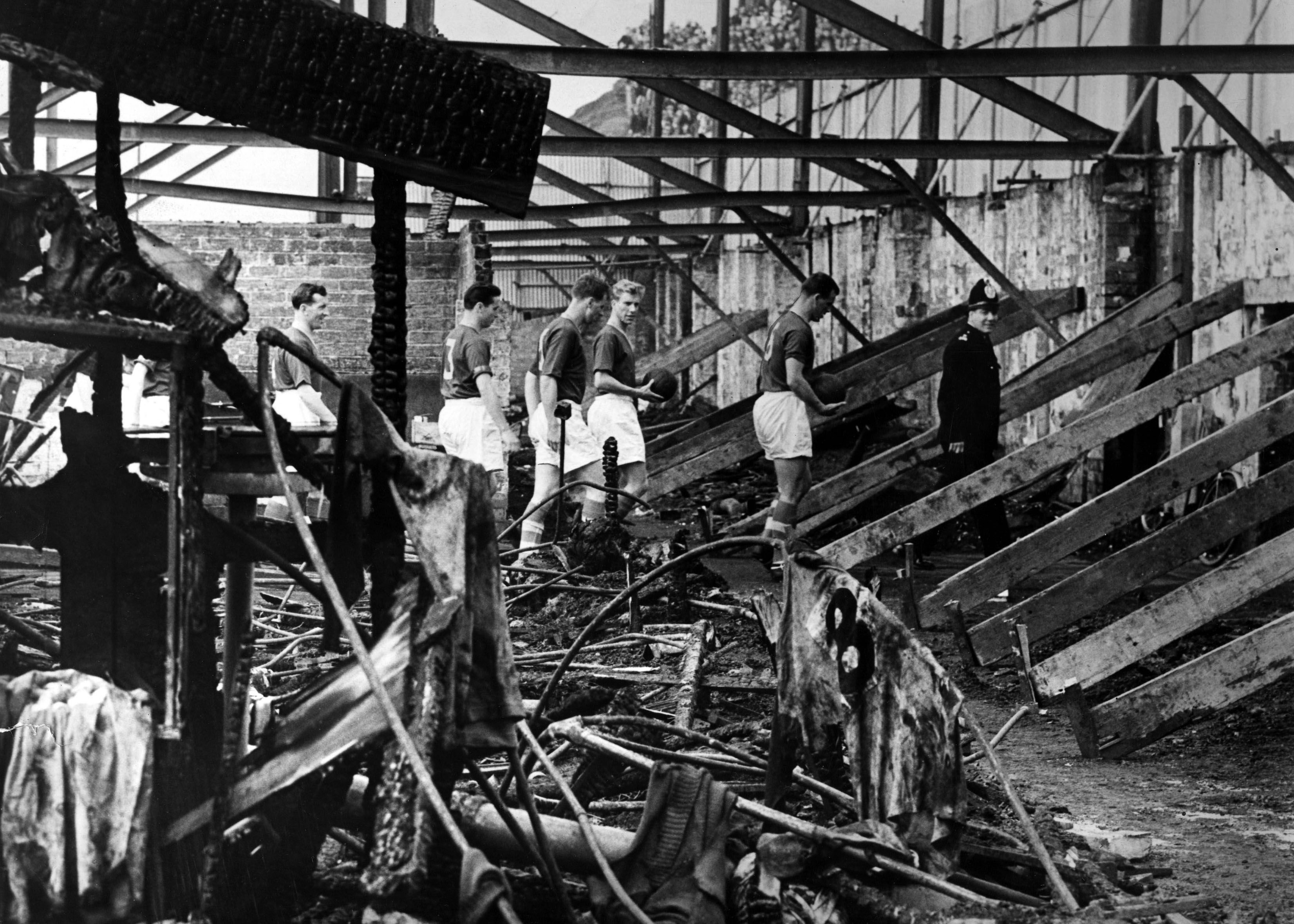 Members of the 1956 Leeds United Team inspecting the West Stand, which was completely destroyed by fire.  Image: © Leeds United Football Club