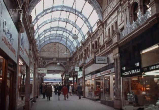 Colour film still of a Victorian arcade in Leeds