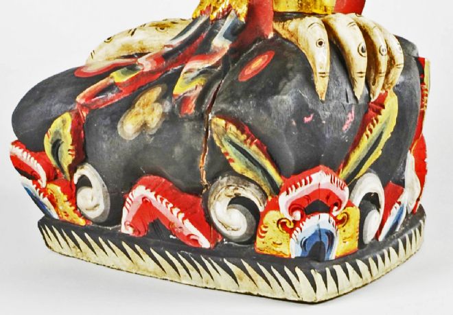 Detail of the feet and base of the sculpture.   The base is decorated with a flower and leaf design.