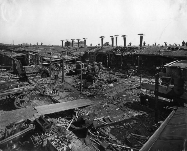 Black and white photograph showing the devastated site of WW1 factory building after an explosion.  Hardly anything is left, everything has been flattened.