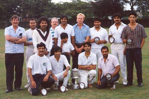 Colour photograph showing an all male cricket team .  The majority of members are of Pakistani heritage.