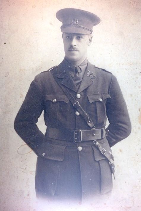 Harry Oldmen in First World War army uniform.  He wears a moustache and stands with his hands behind his back.