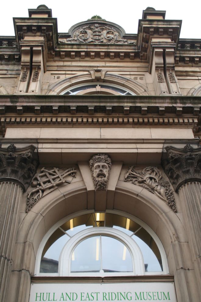 Close up Photograph showing part of the Corn Exchange, now a Museum, showing stone carvings and decorated exterior.