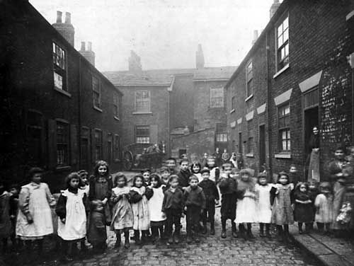 Back to back terraced housing with a group of children standing in the foreground. Photo taken in 1901